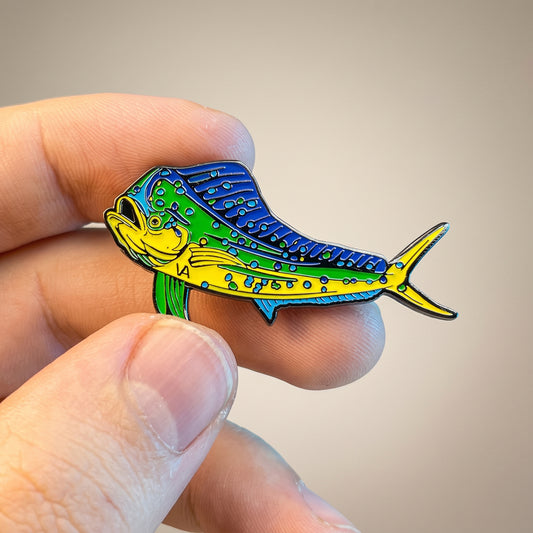 Close-up of Mahi Mahi hard enamel pin held in hand