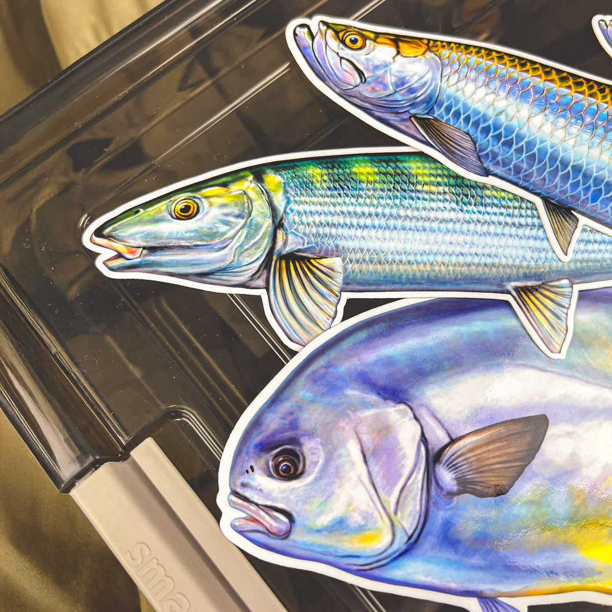 Permit sticker alongside Tarpon and Bonefish stickers on a rod case, the saltwater Grand Slam trio
