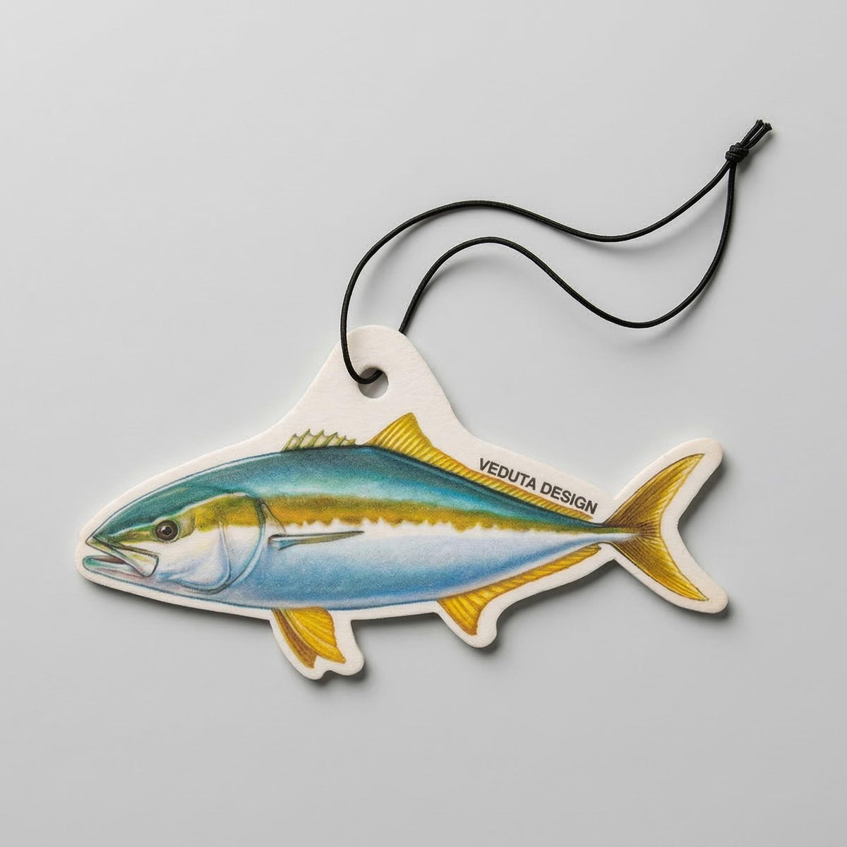 Yellowtail Kingfish air freshener with hanging cord on a light background