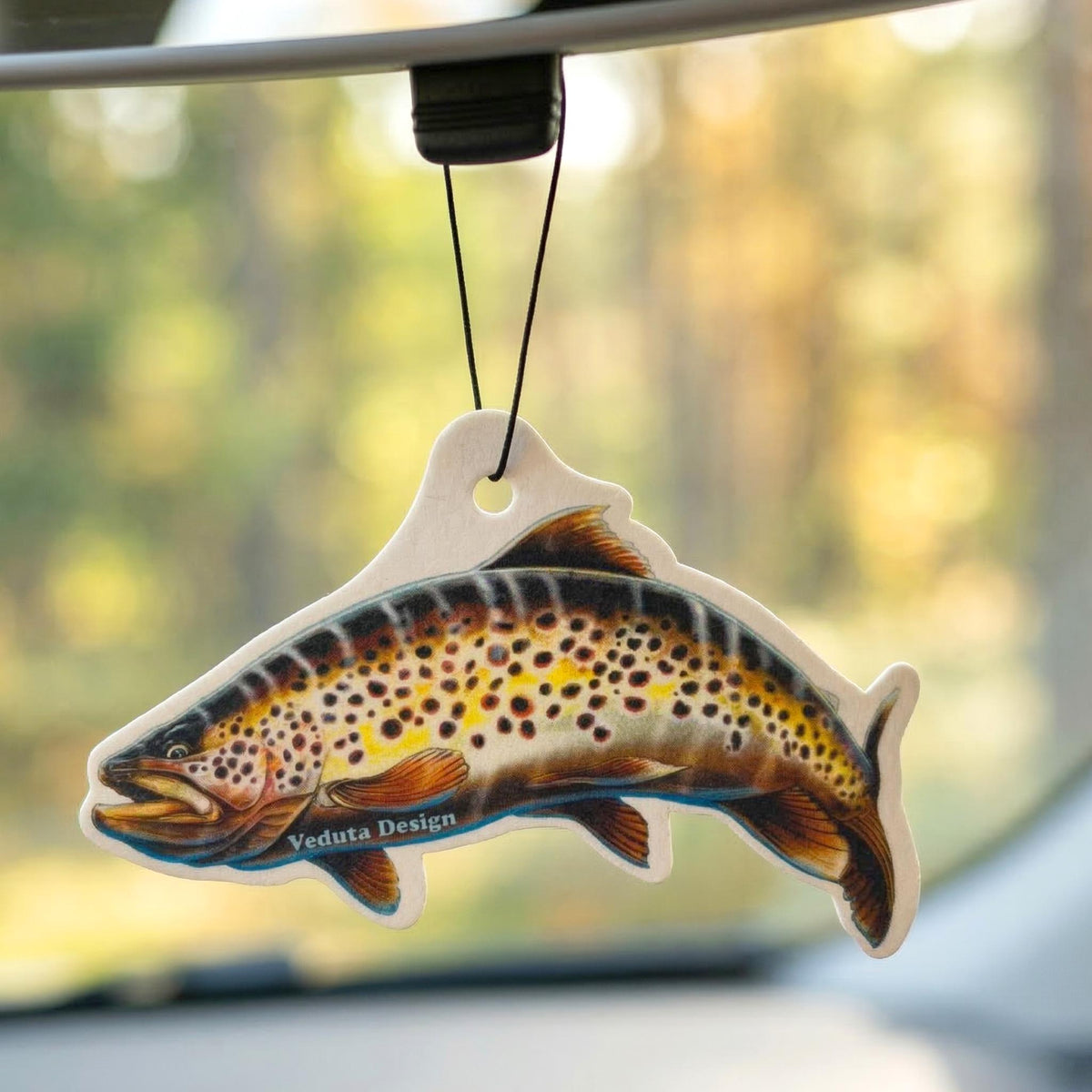 Brown Trout air freshener hanging in a car