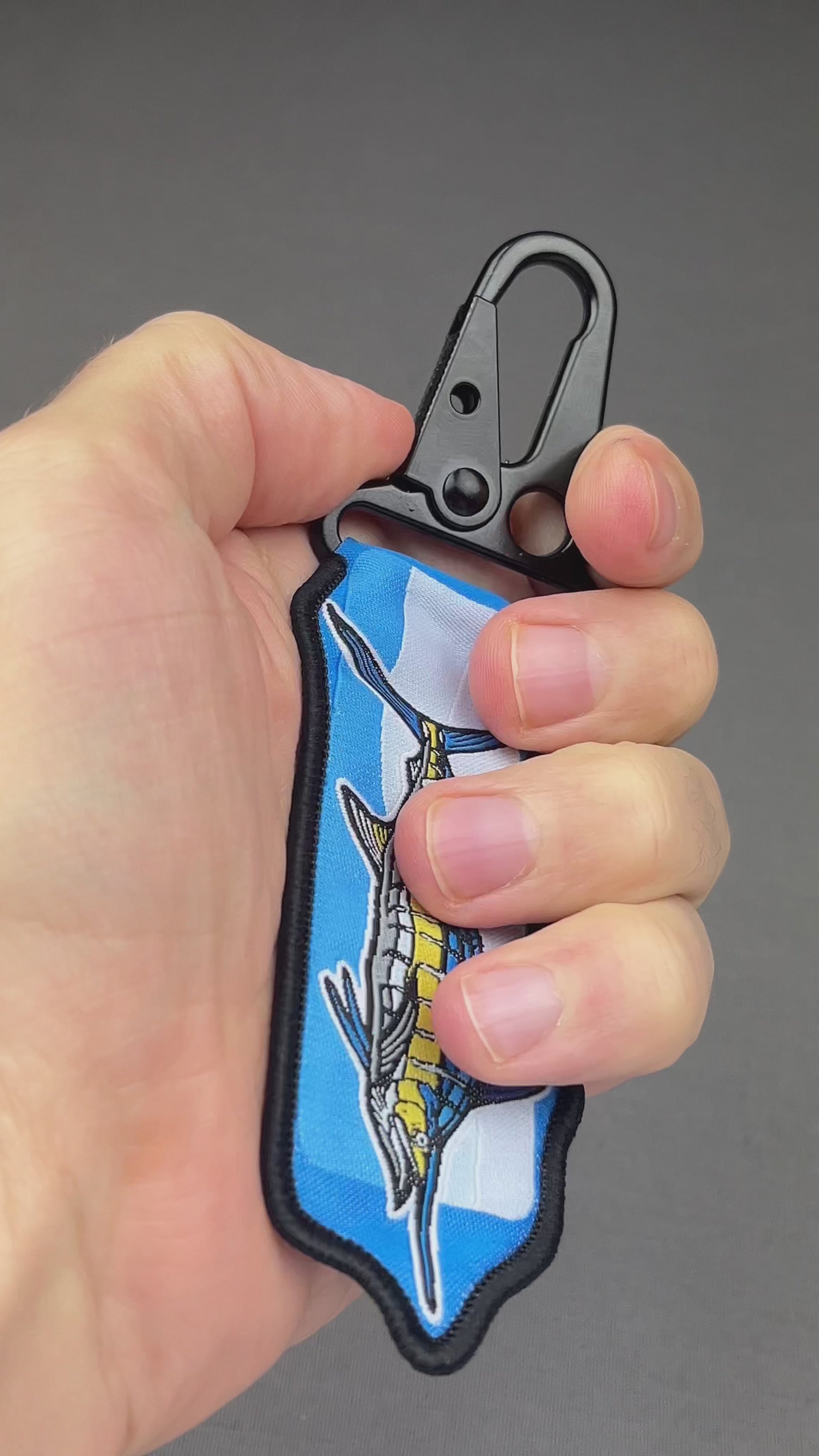 Video of the Blue Marlin woven keychain with jacquard fabric tag and black carabiner clip