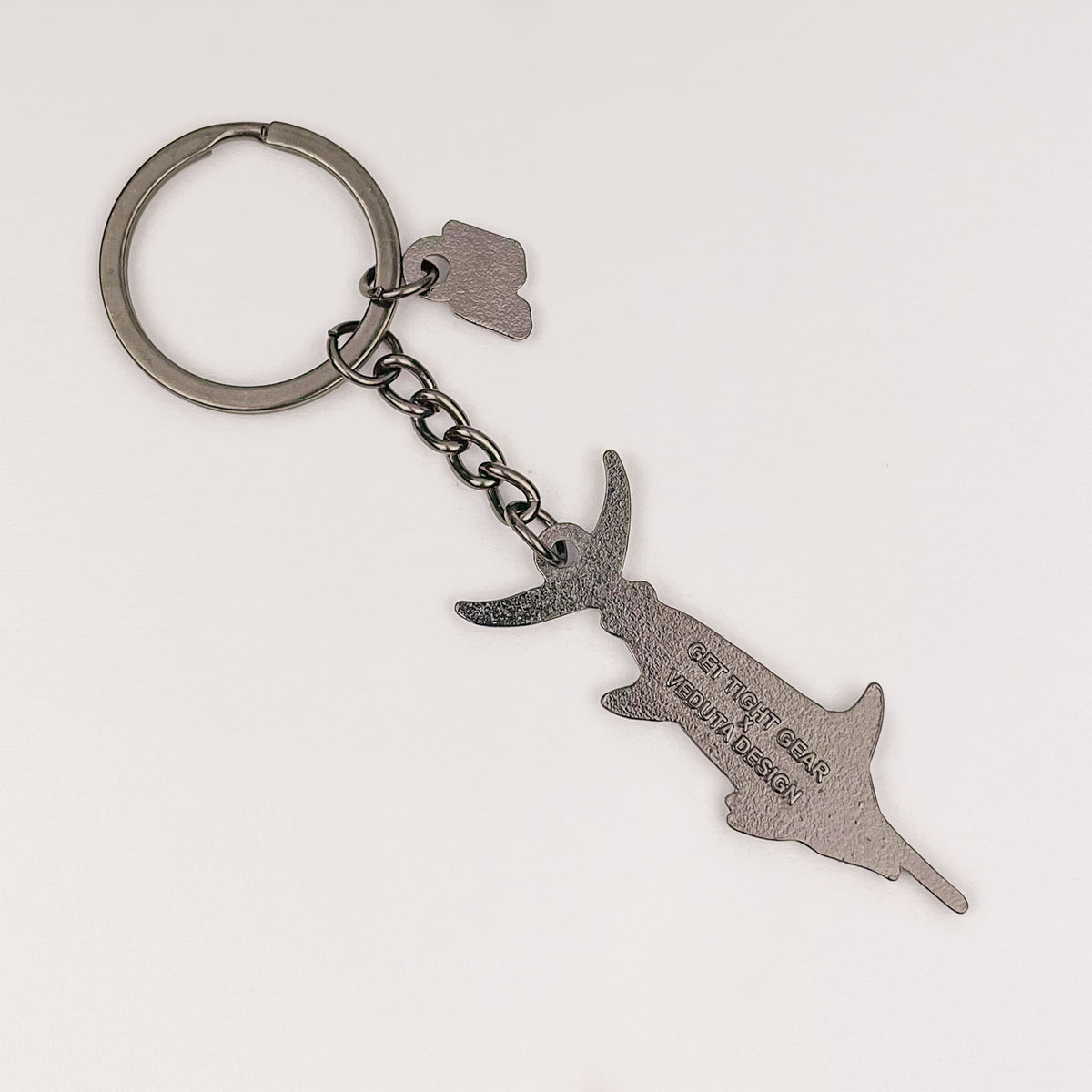 Back of the Blue Marlin keychain charm with embossed Get Tight Gear x VEDUTA DESIGN logo