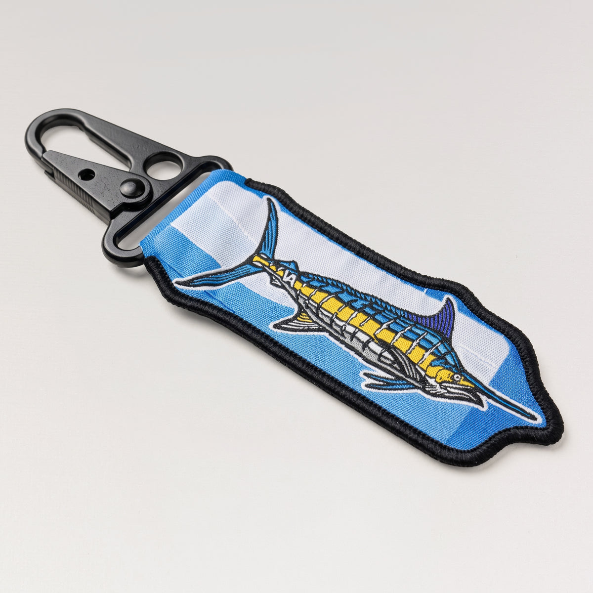 Full length of the Blue Marlin woven keychain with carabiner clip, angled view
