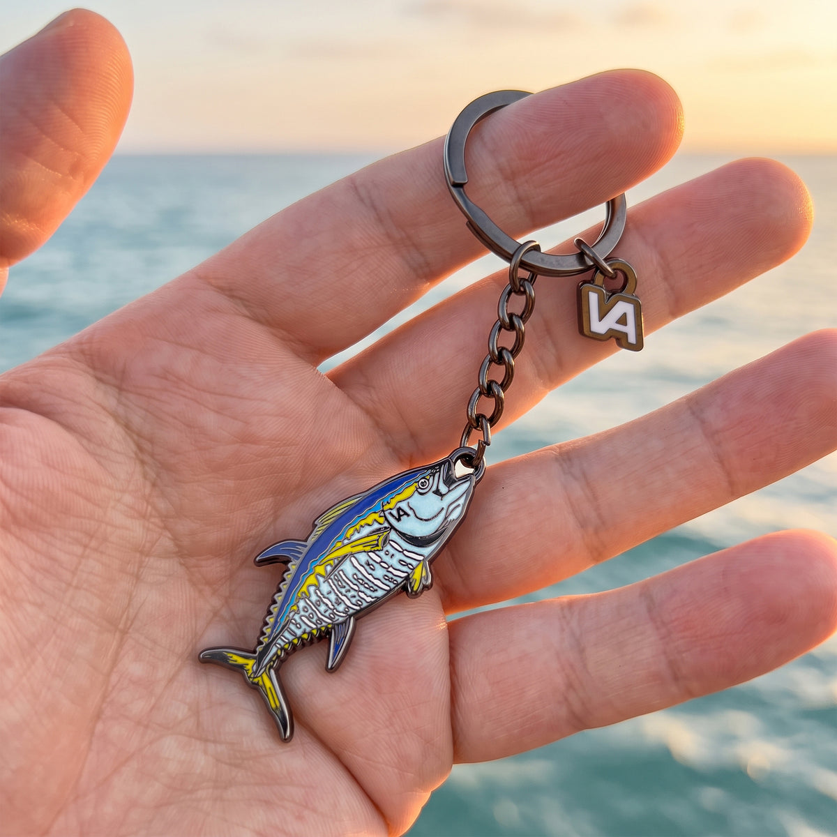 Bluefin Tuna keychain held in hand with the ocean in the background