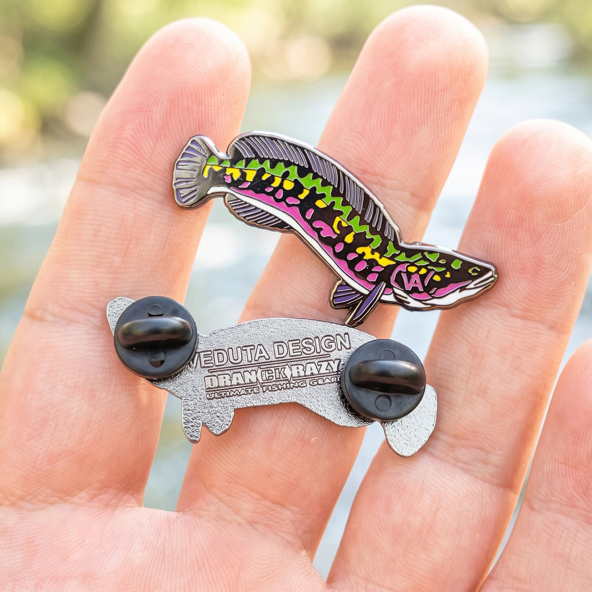 Giant Snakehead pin held in hand with clutch backs and back piece