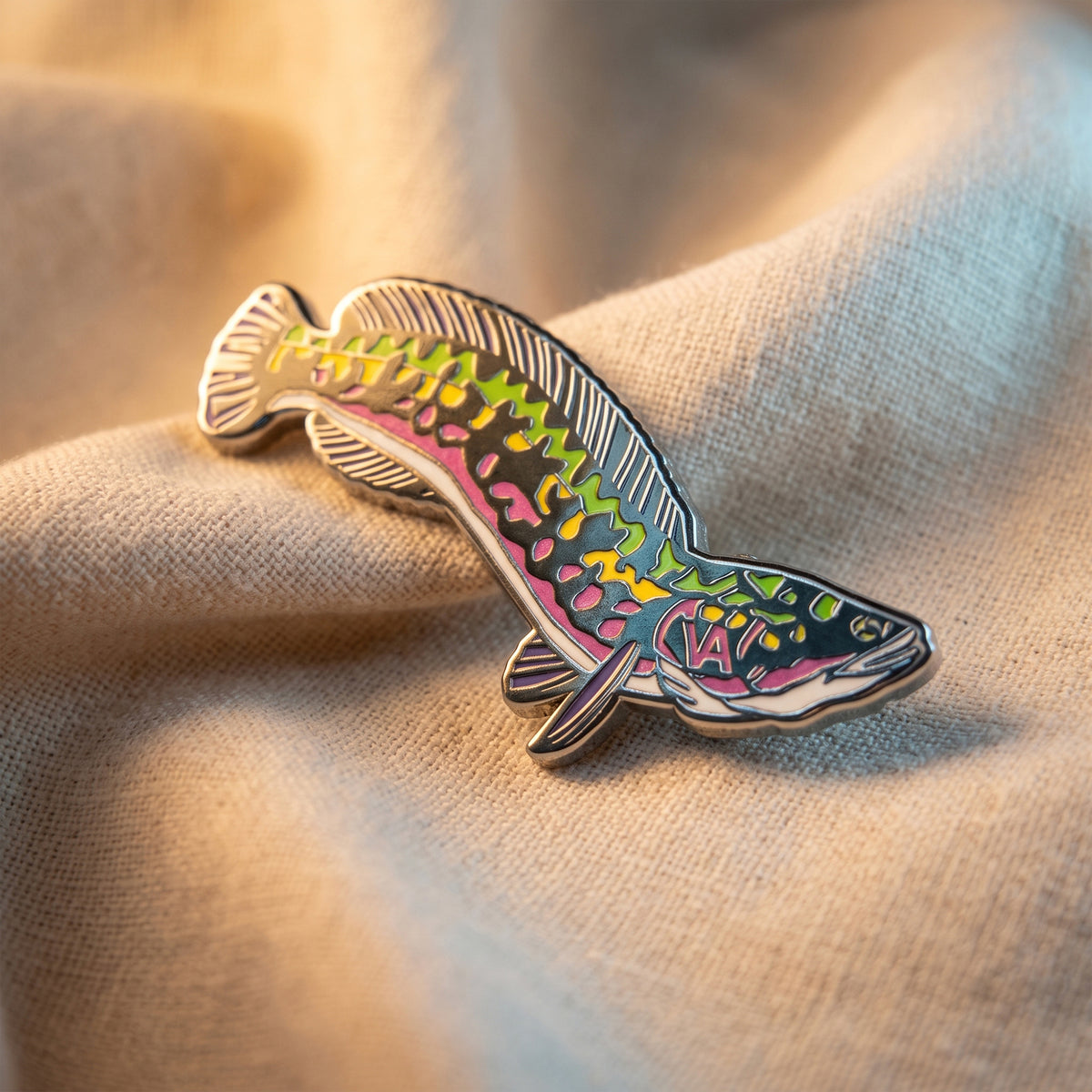 Giant Snakehead pin resting on burlap fabric