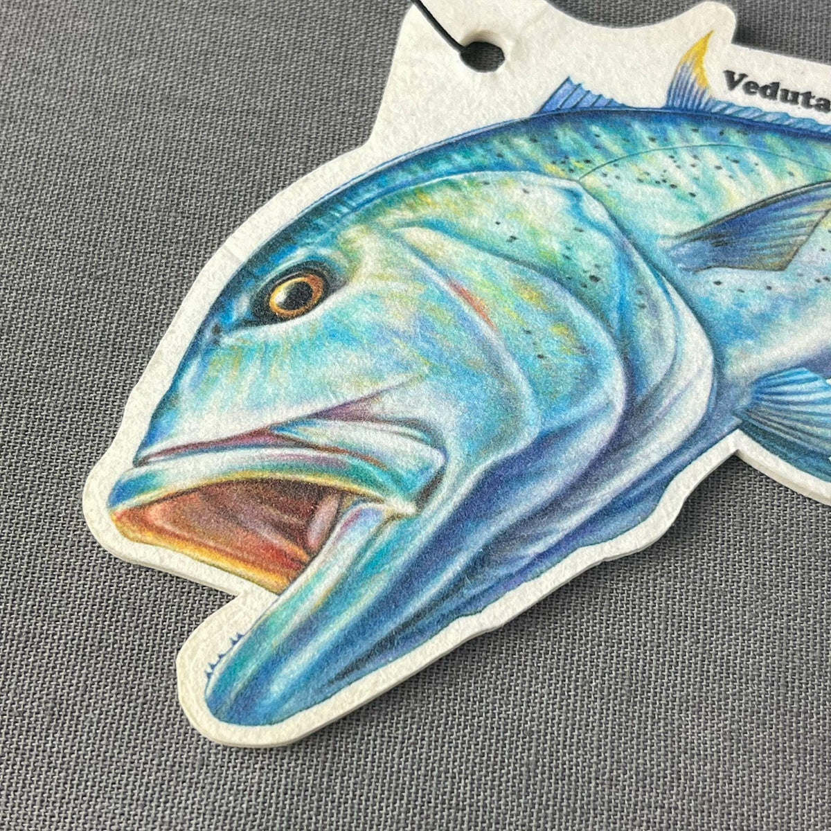 Close-up of the hand-drawn Giant Trevally artwork on the air freshener