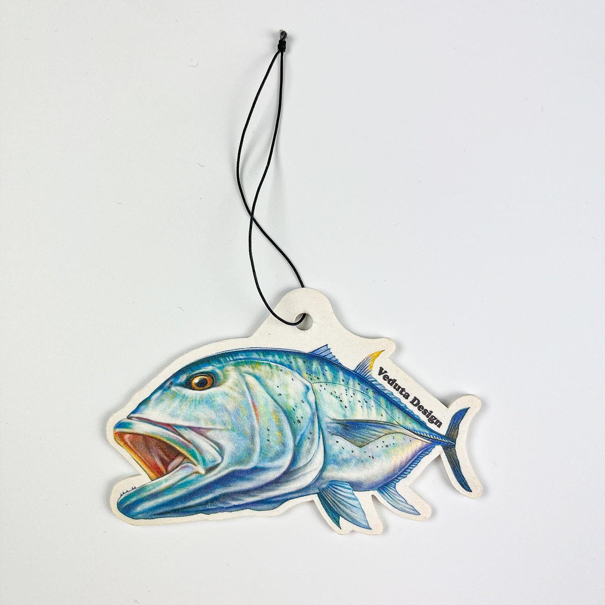 Giant Trevally air freshener with hanging cord on a light background