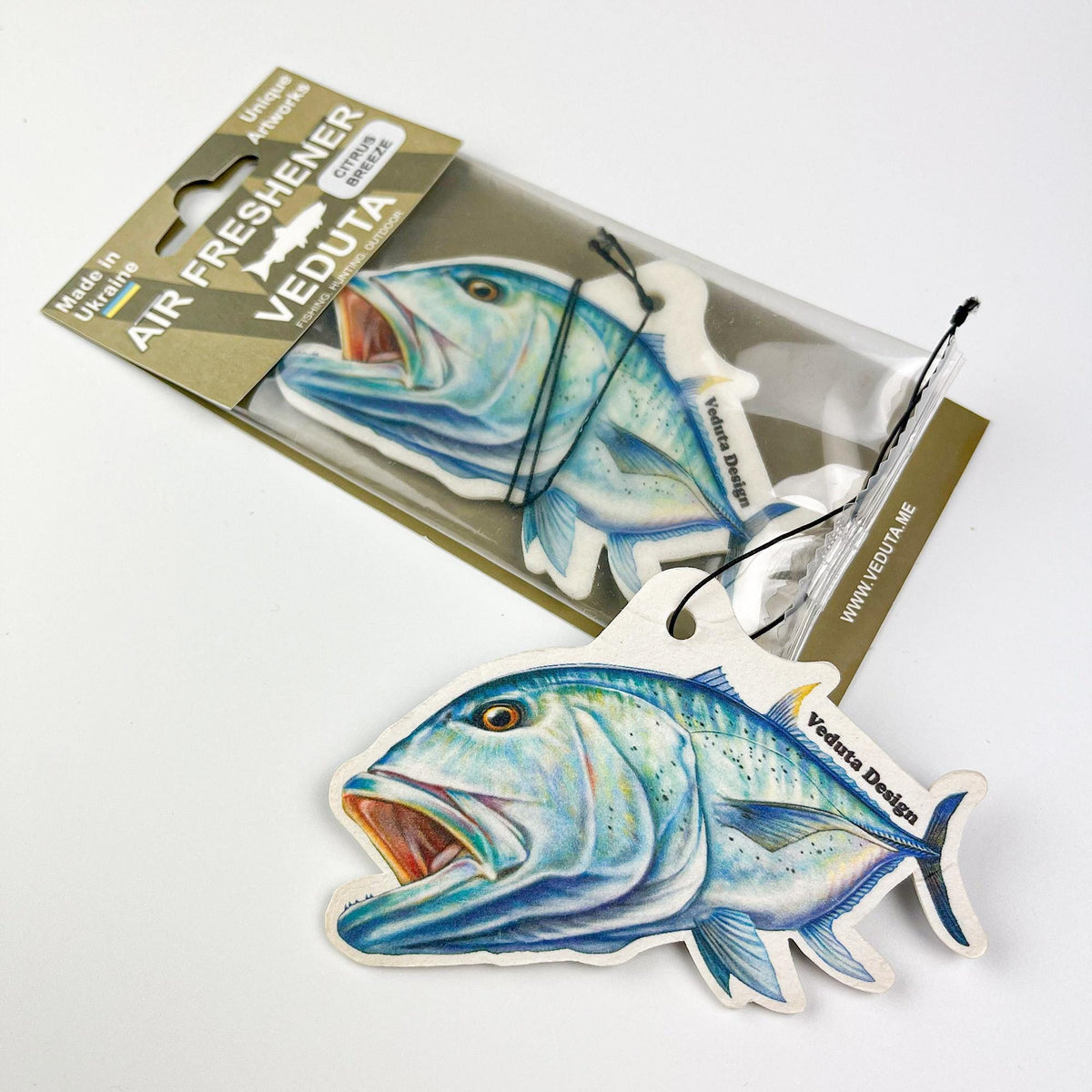 Giant Trevally air freshener next to its sealed VEDUTA DESIGN package