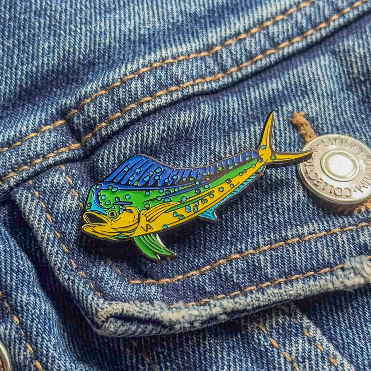 Mahi Mahi pin on a denim jacket pocket
