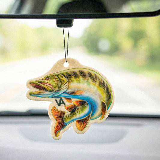 Northern Pike air freshener hanging from a rearview mirror with the road behind