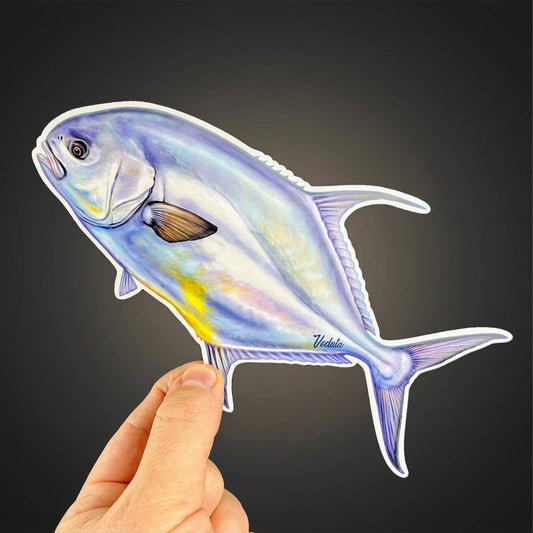 Permit sticker held in hand against a dark background, flats fly fishing decal