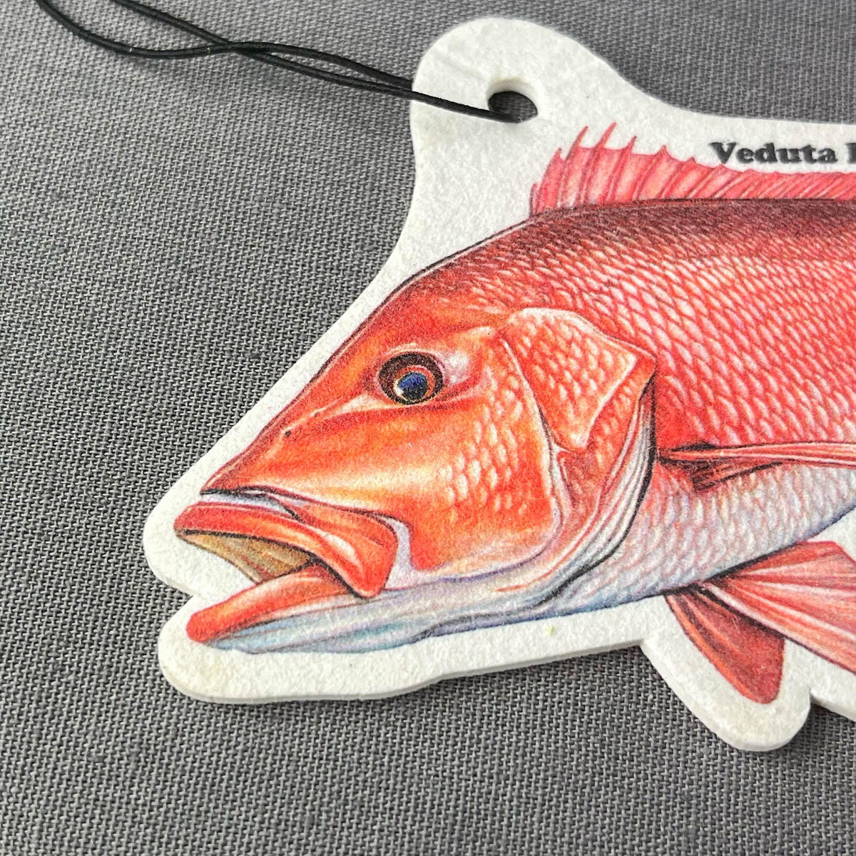 Close-up of the hand-drawn Red Snapper artwork on the air freshener