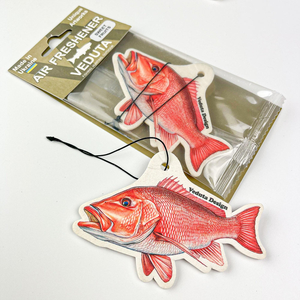 Red Snapper air freshener next to its sealed VEDUTA DESIGN package