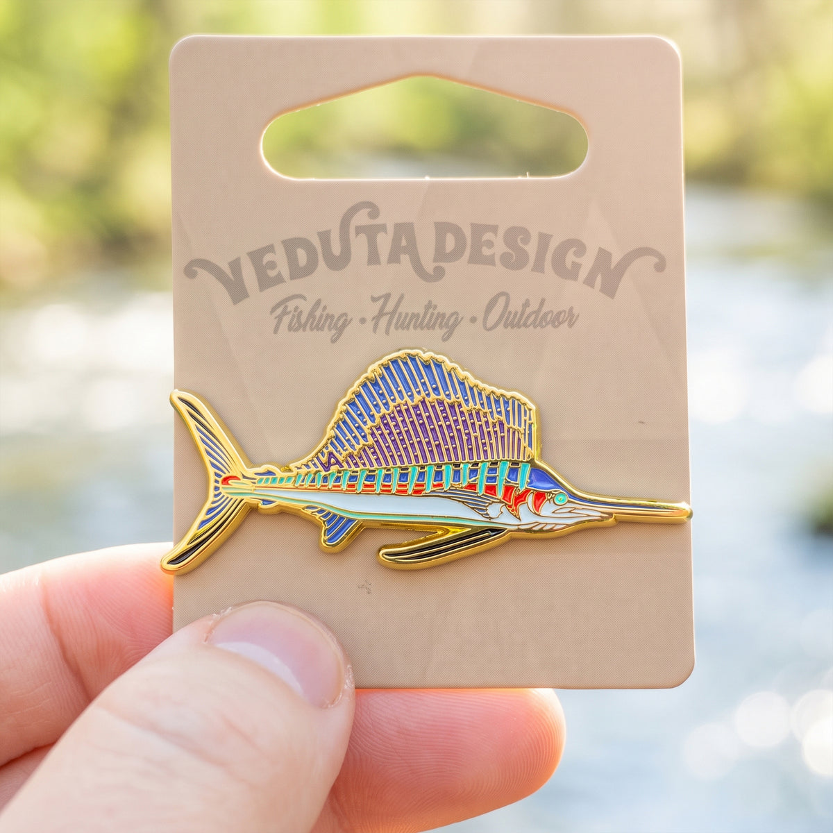 Sailfish pin on VEDUTA DESIGN branded card, held outdoors