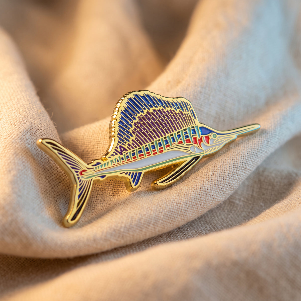 Sailfish pin close-up on knit fabric texture
