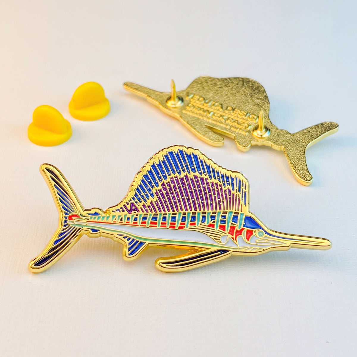 Sailfish pin with two yellow rubber clutch backs