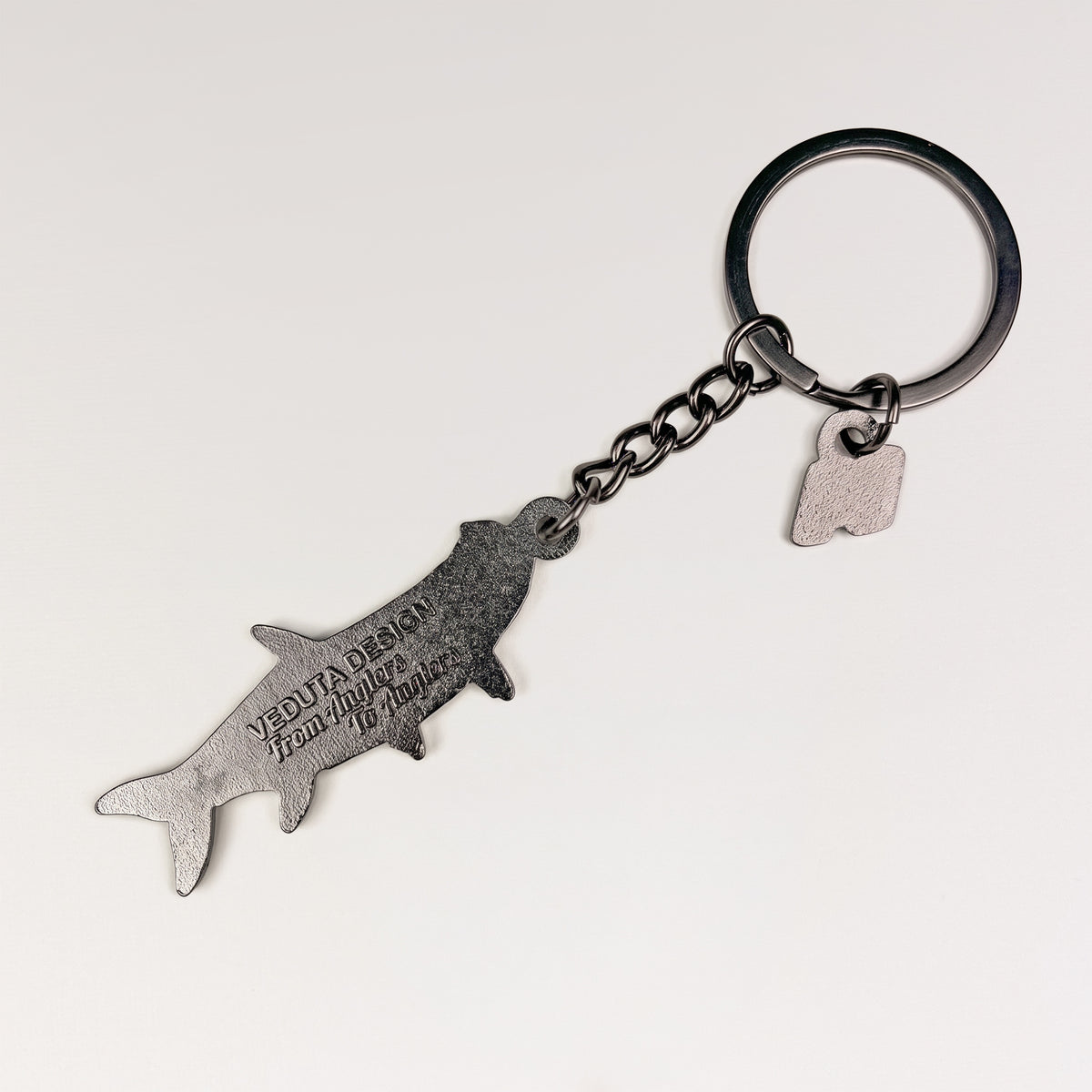 Back of the Tarpon keychain charm with embossed VEDUTA DESIGN — From Anglers to Anglers logo