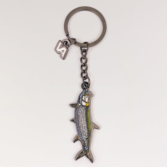 Tarpon keychain, black nickel hard enamel charm with the VEDUTA DESIGN VA logo charm and chain, on a light studio background