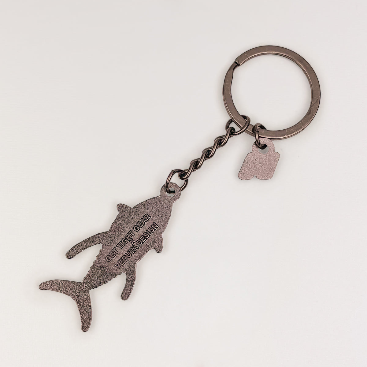 Back of the Yellowfin Tuna keychain charm with embossed Get Tight Gear x VEDUTA DESIGN logo