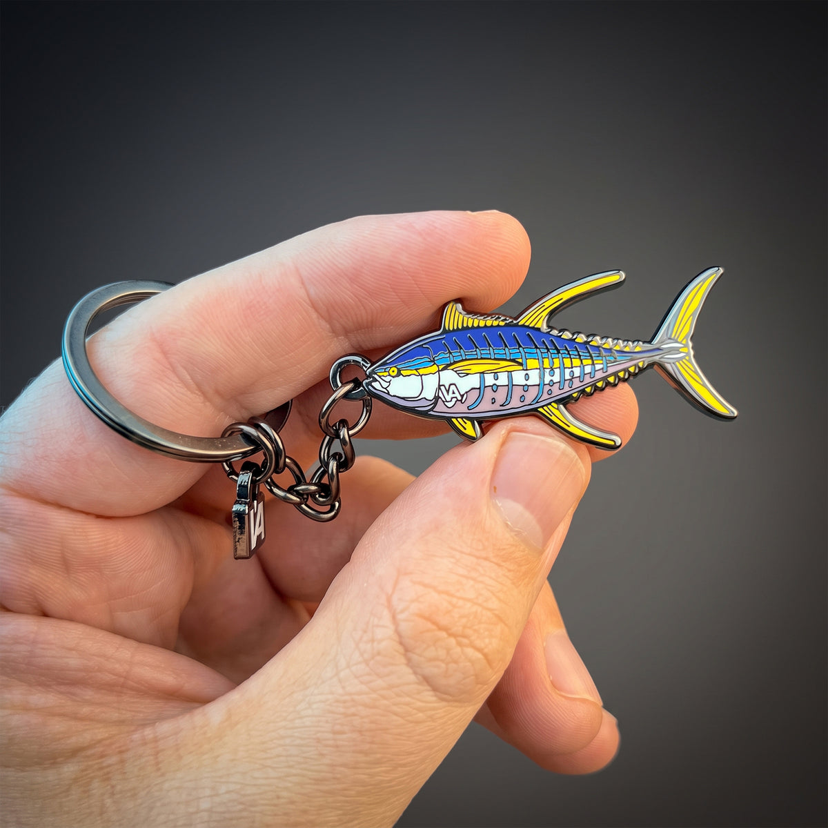 Yellowfin Tuna keychain held in hand against a dark background