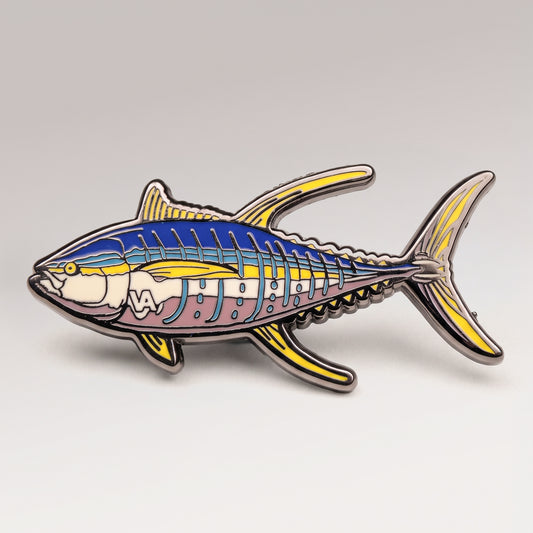 Blue and yellow enamel Yellowfin Tuna pin on a light studio background