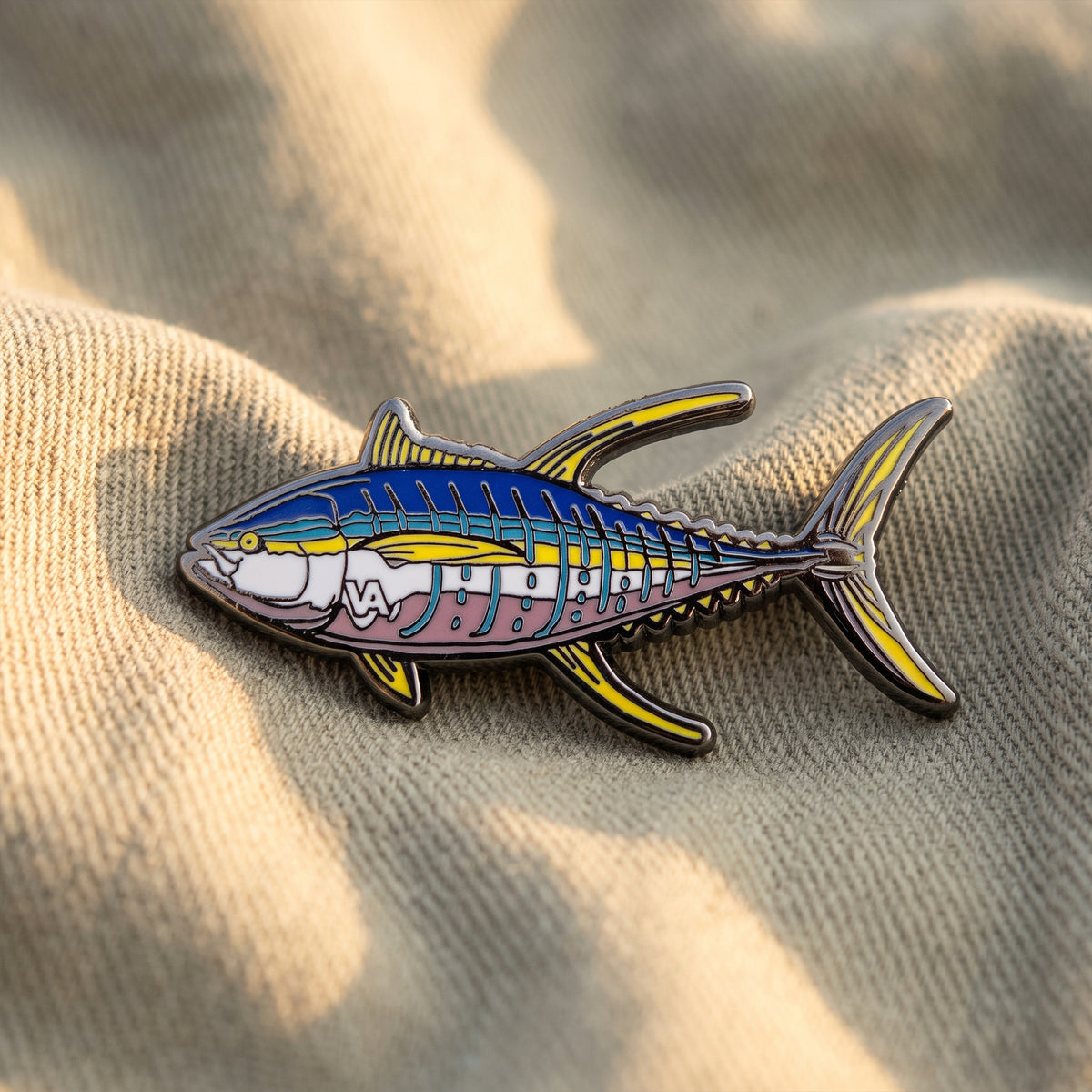 Yellowfin Tuna pin in warm light on fabric backdrop