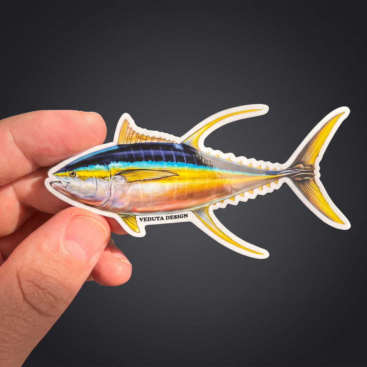 Close-up of Yellowfin Tuna sticker held between fingers