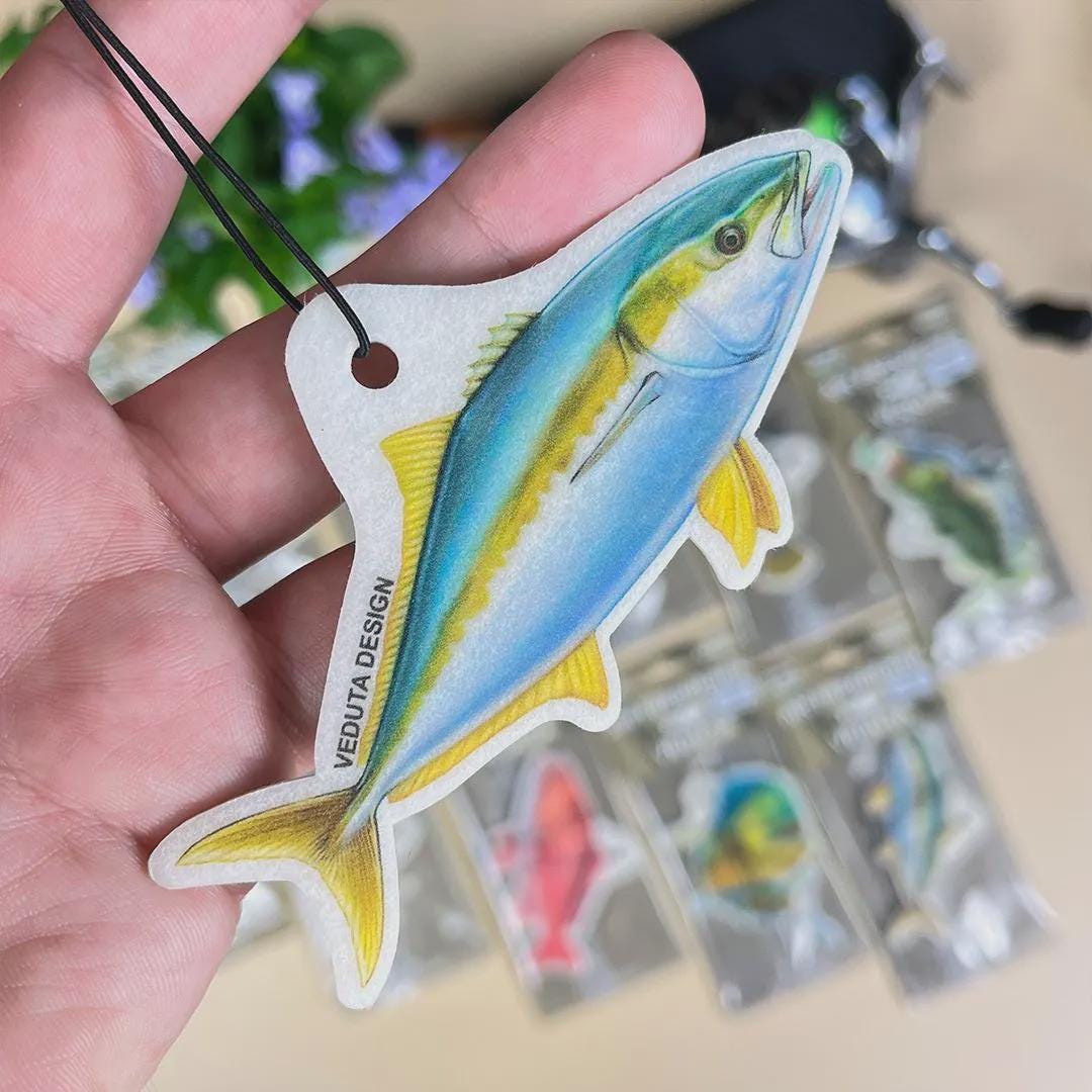 Yellowtail Kingfish air freshener held in hand